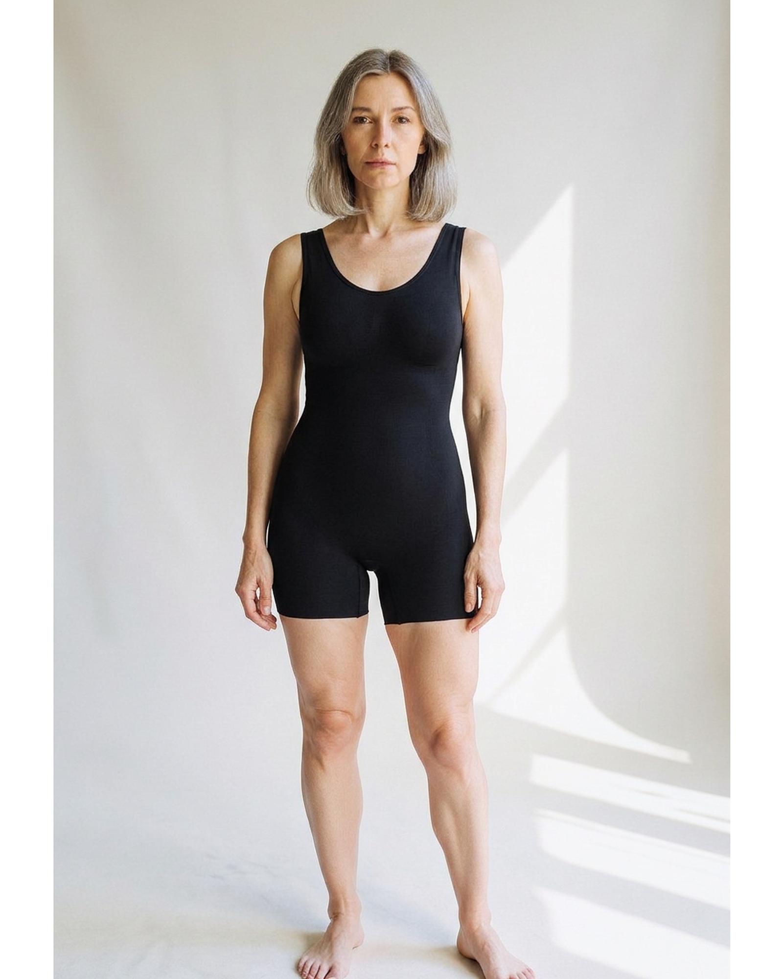 Aafje · Mid-thigh bodysuit shaper – black, worn on model (AI visualisation)