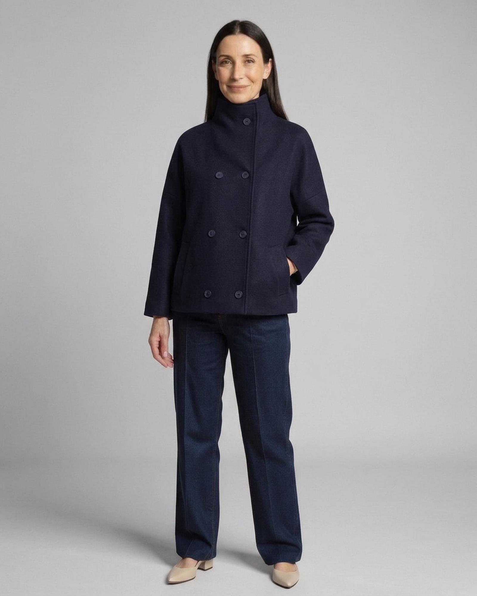 Aleida navy relaxed double-breasted wool coat with high stand collar and welt pockets, three-quarter view (AI visualisation)
