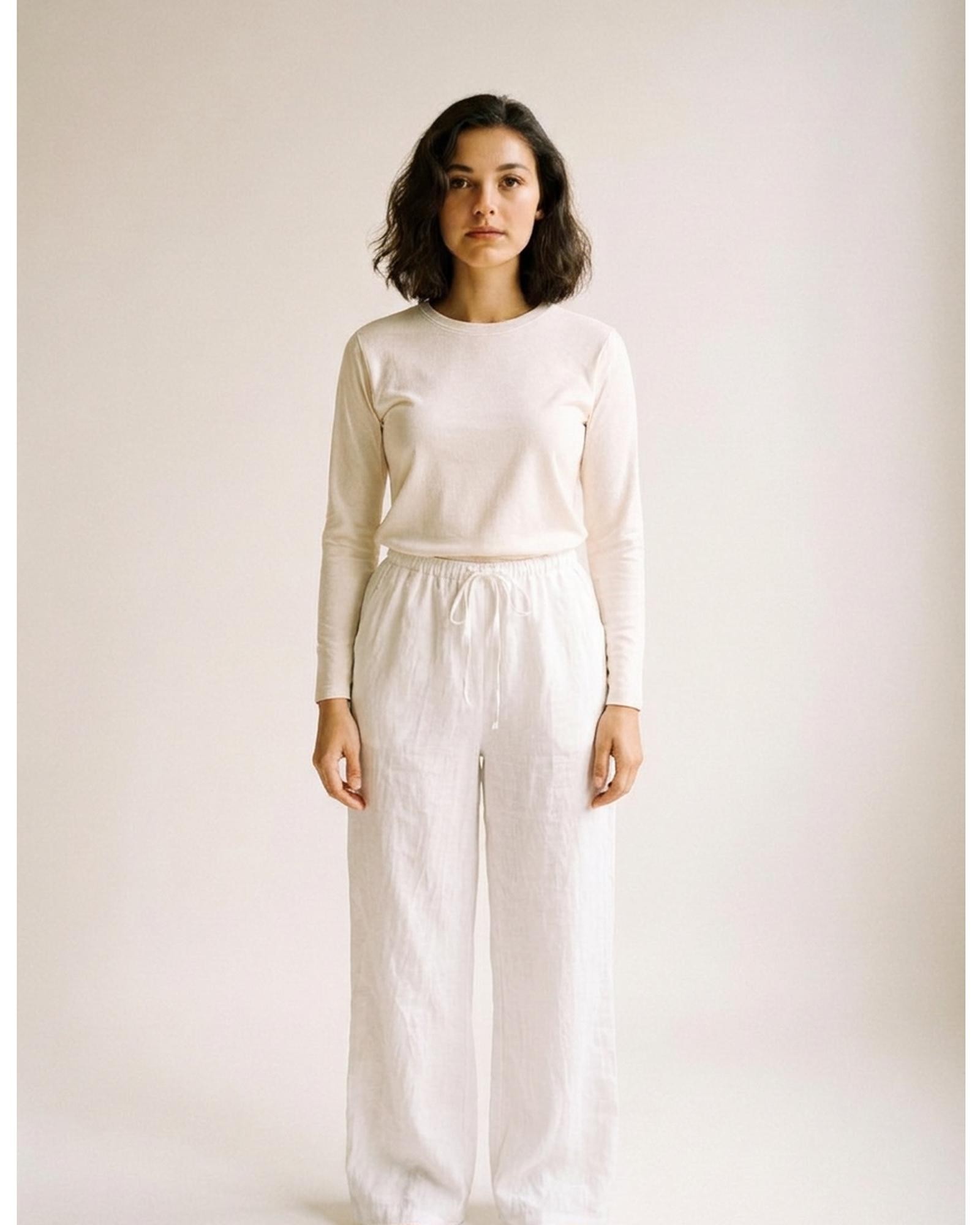 Bregtje · High-waist linen wide-leg trousers — white, worn front (AI visualisation)