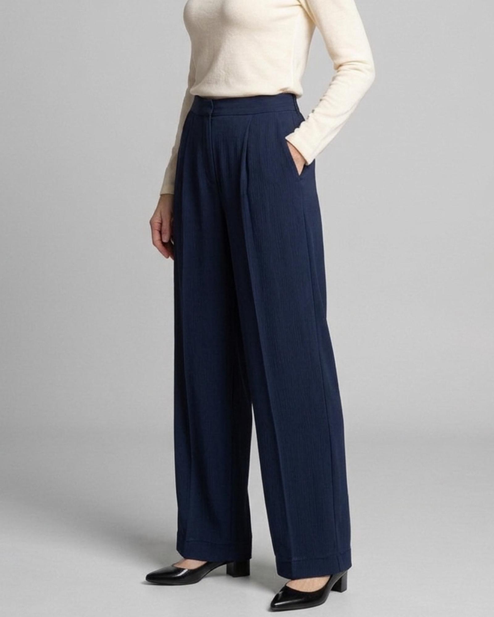 Britt · High-waist wide-leg trousers — on the model, three-quarter view (AI visualisation)