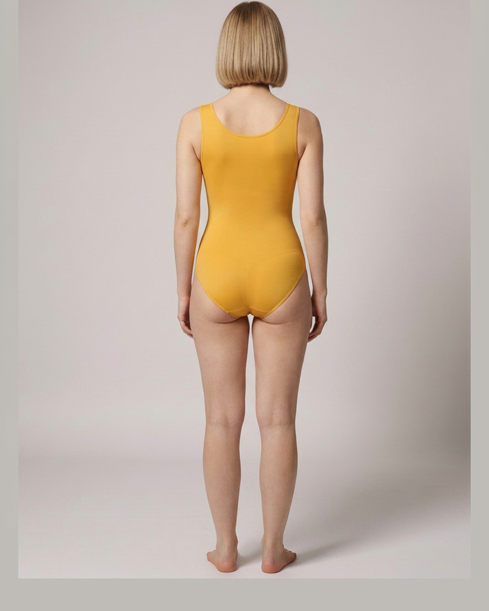 Coba · Scoop-neck shaping bodysuit — Gold, worn on model, back view (AI visualisation)