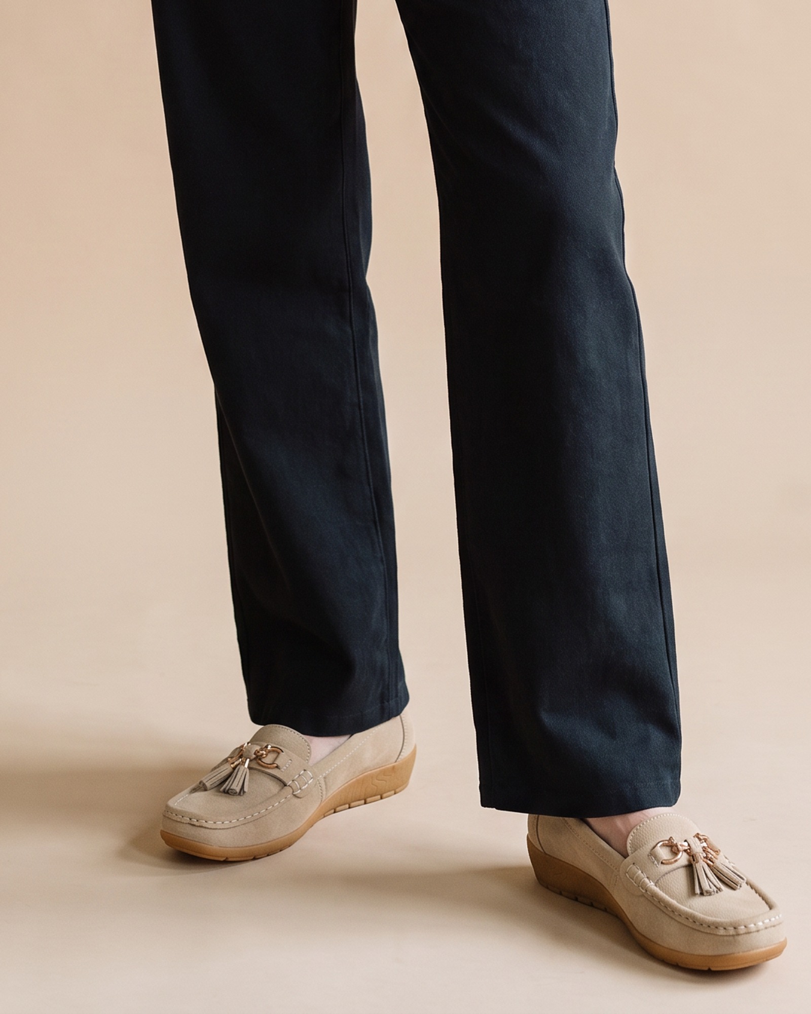 Cootje leather tassel moccasin, worn on model — lower-body view (AI visualisation)