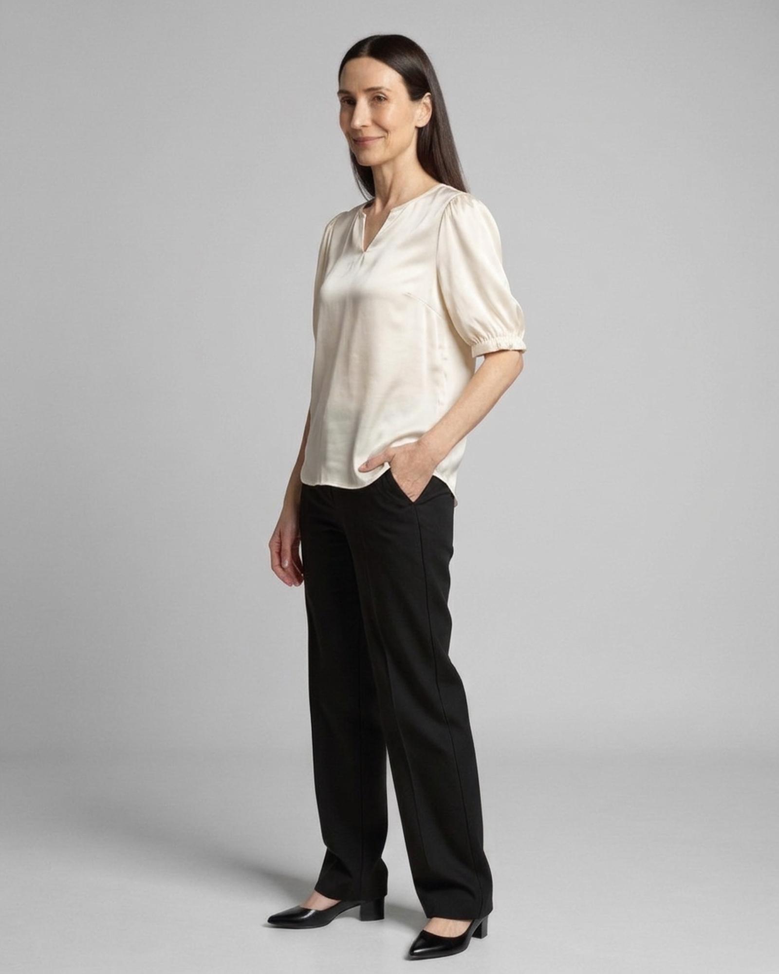 Corinne · Puff-sleeve satin blouse — on model, three-quarter (AI visualisation)