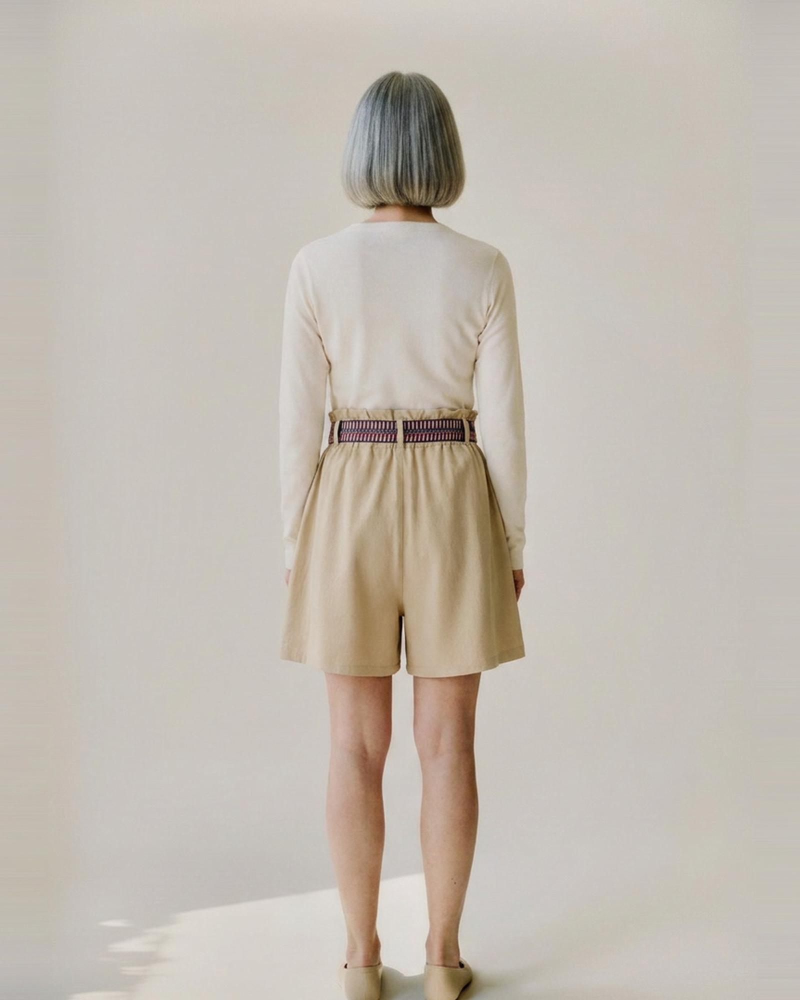 Lieneke · Paperbag tie-belt shorts — on model, back (AI visualisation)