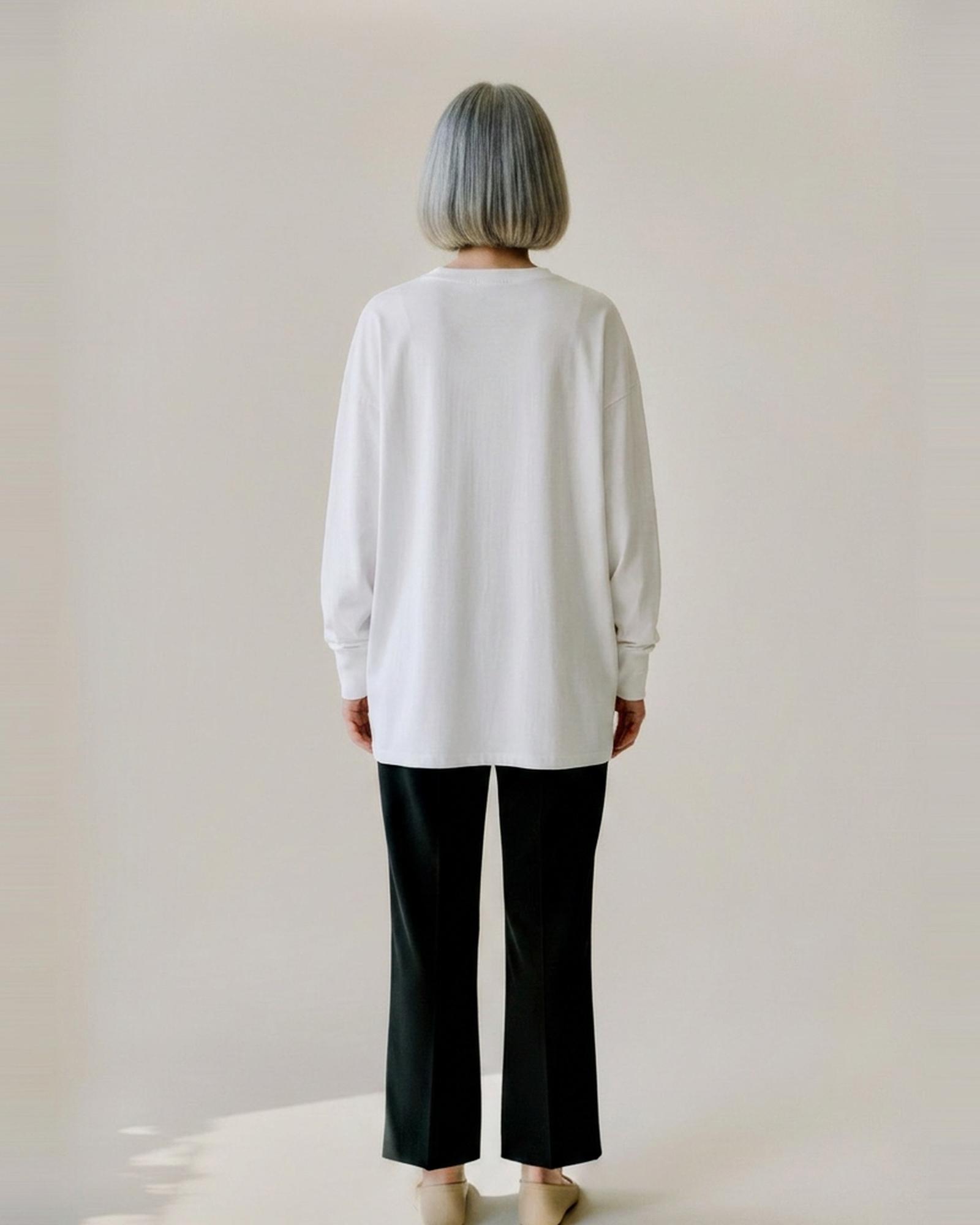 Marloes · Loose cotton long-sleeve tee — on model, back (AI visualisation)