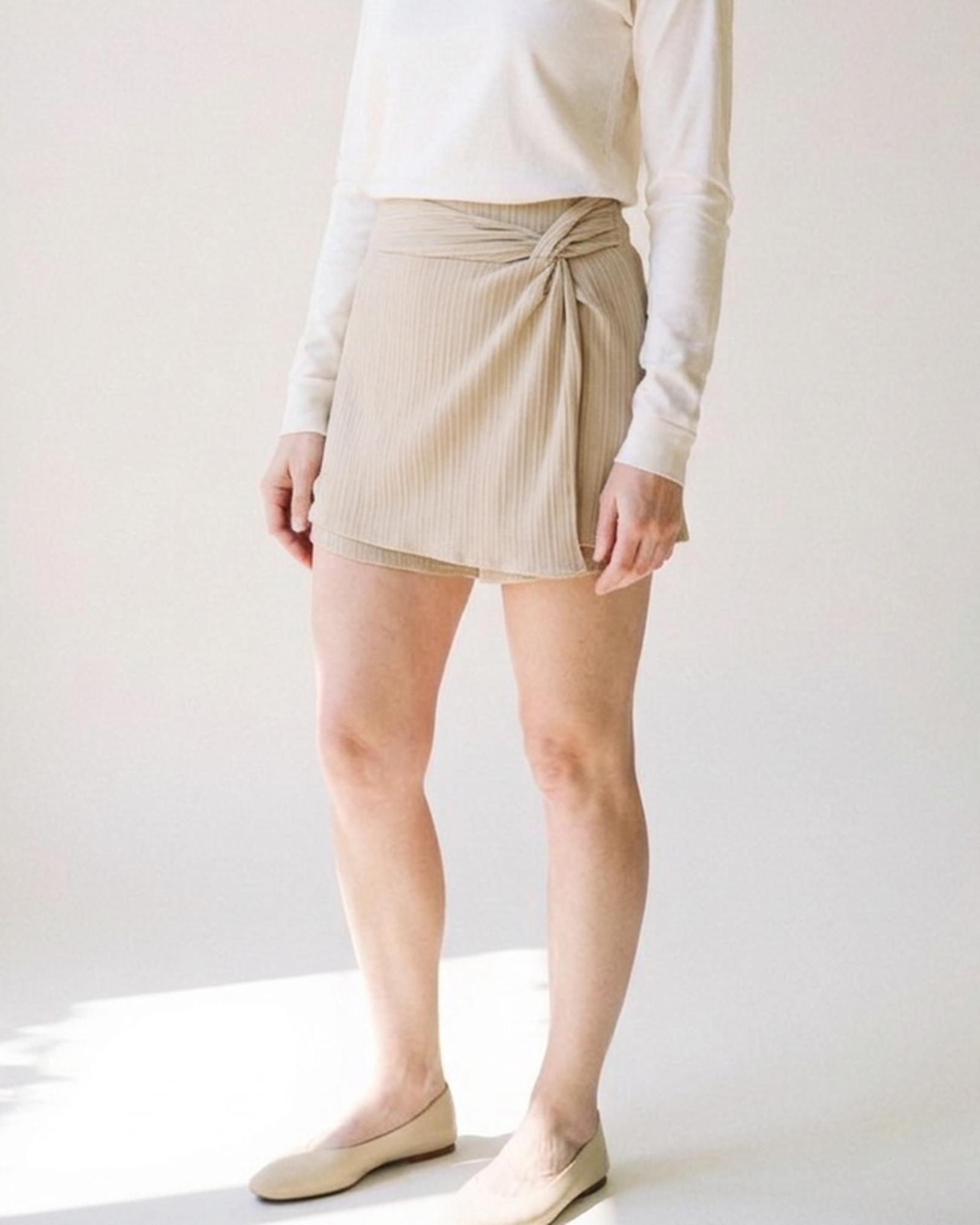 Martje · Twist-front skort — on model, three-quarter (AI visualisation)