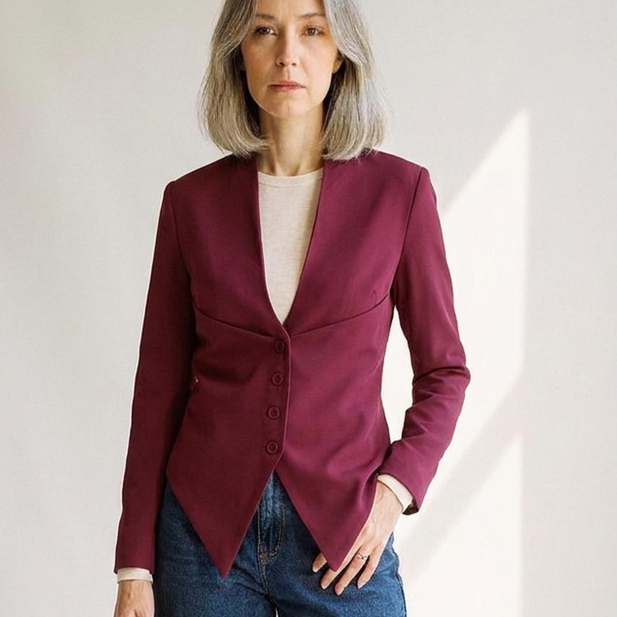 Petronella wine-red collarless slim-fit blazer coat with deep V neckline and fabric buttons, detail view (AI visualisation)