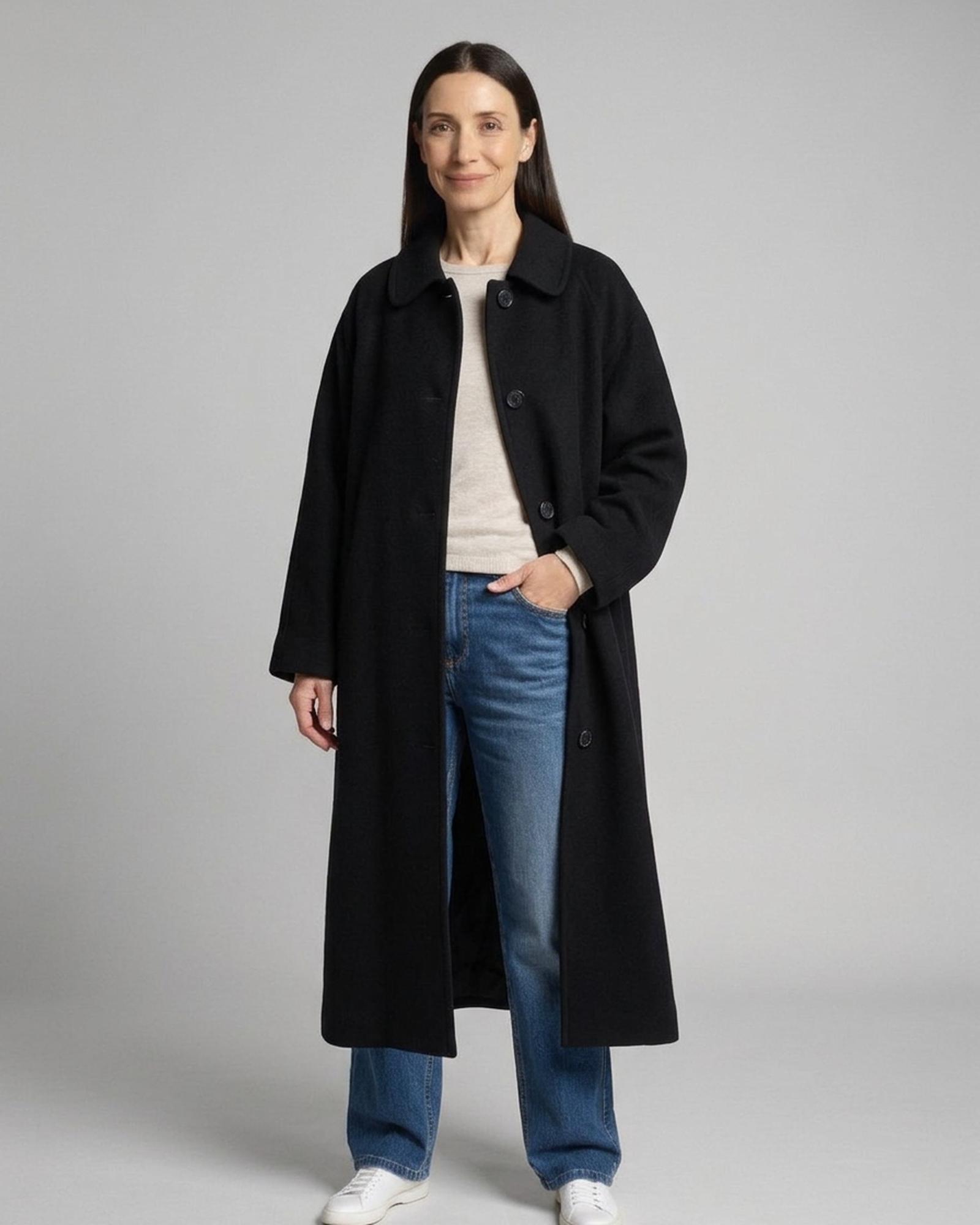 Willemke black oversized long wool coat in Hepburn style with small rounded collar, three-quarter view (AI visualisation)
