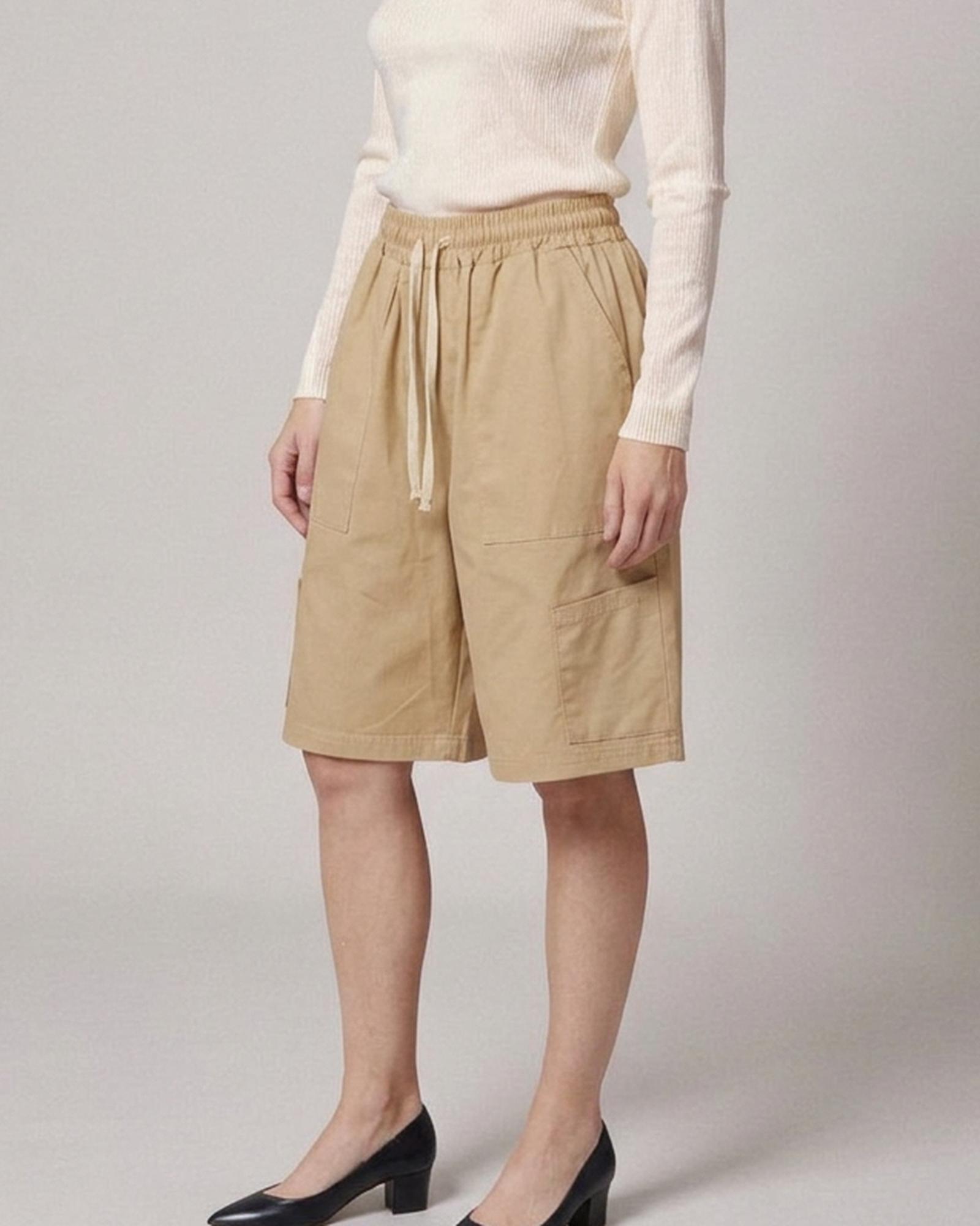 Wobke · Utility wide-leg shorts — on model, three-quarter (AI visualisation)