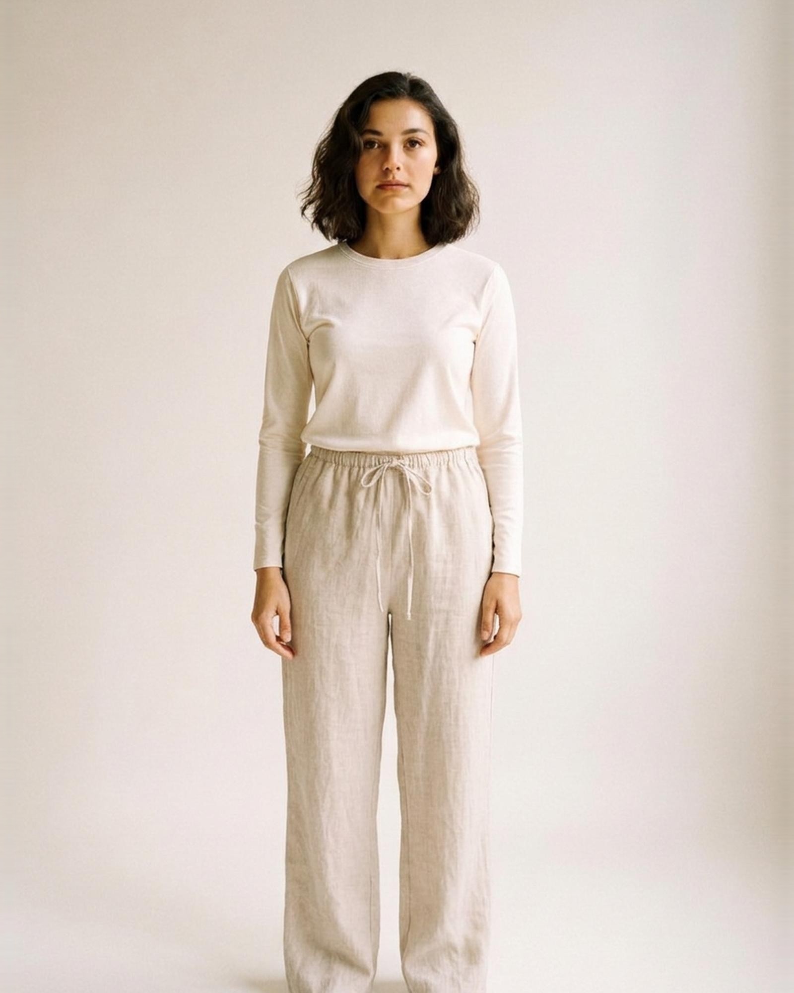 Bregtje · High-waist linen wide-leg trousers — natural linen, worn front (AI visualisation)