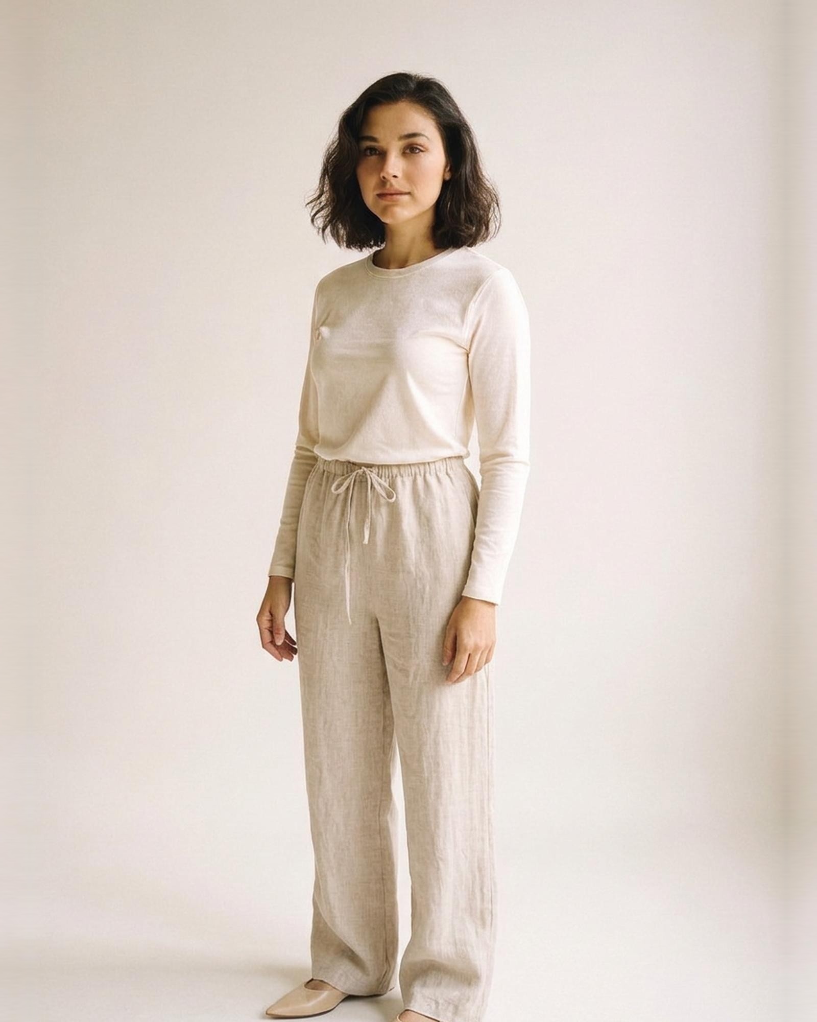 Bregtje · High-waist linen wide-leg trousers — natural linen, three-quarter view (AI visualisation)