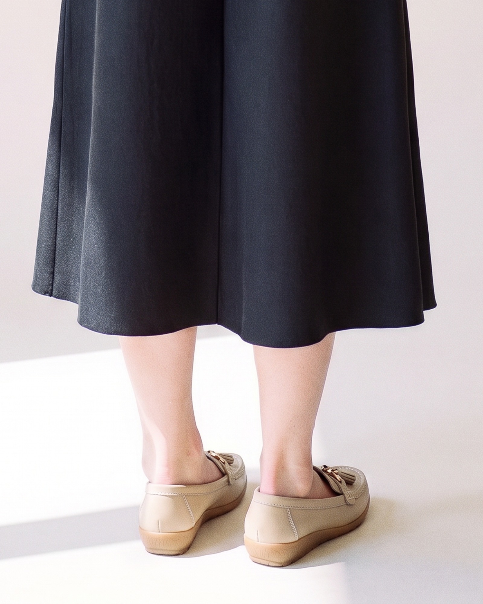 cootje leather tassel moccasin — back view on model (AI visualisation)
