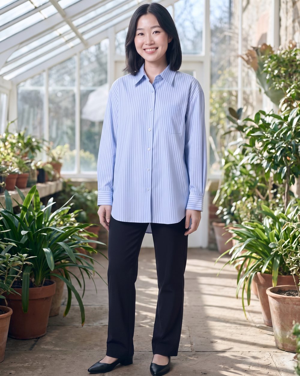 Light-blue striped shirt blouse in a winter garden
