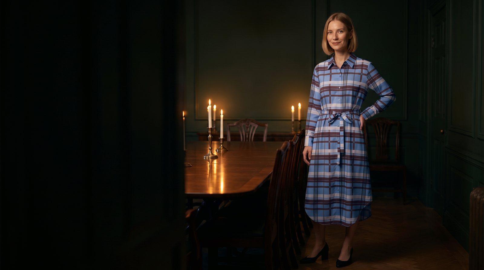 Blue-brown checked belted shirt dress in a candlelit dining room